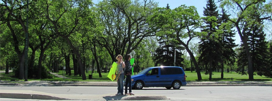 Students stand on the Main Street median to bring in customers for the annual Grad BBQ. Funds raised go to a local charity. (2010-2011) Grad BBQ
